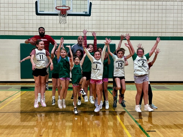 Mendon 4th and 5th grade Rising Stars team jumping in the air